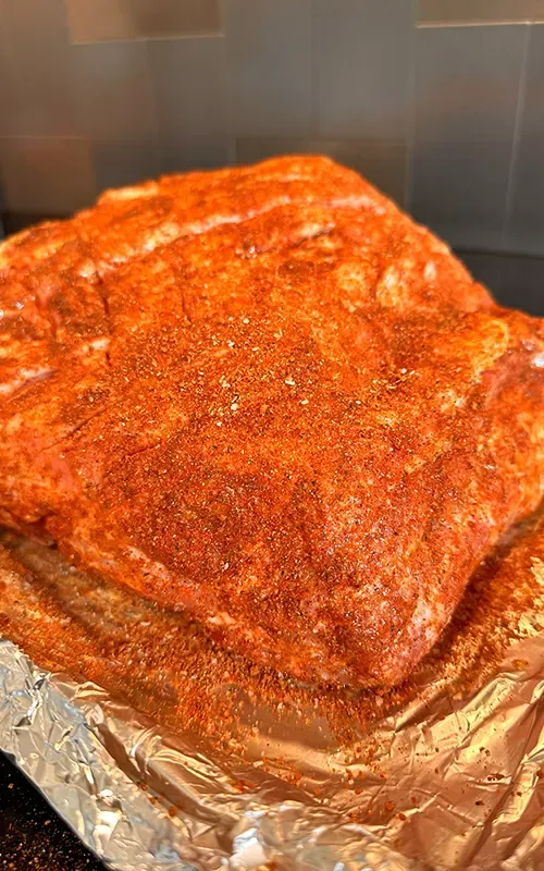 Pork butt coated all over in a red spice rub