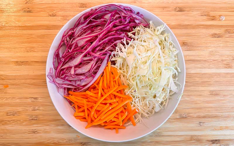 Sliced cabbage and carrots in a bowl