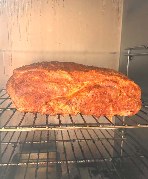 Smoking the pork butt in the smoker.