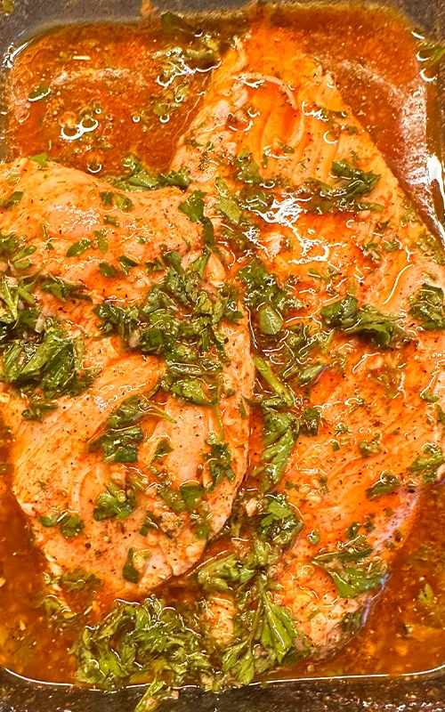 Chicken marinating for the Mediterranean Rice Bowl Recipe.